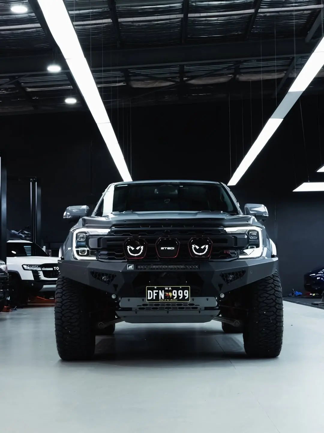Ford Raptor, the front of the truck in the showroom.