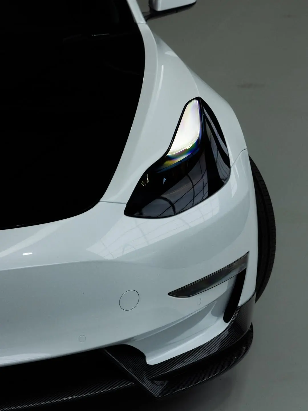 Tesla Model 3, the headlight and front lip.