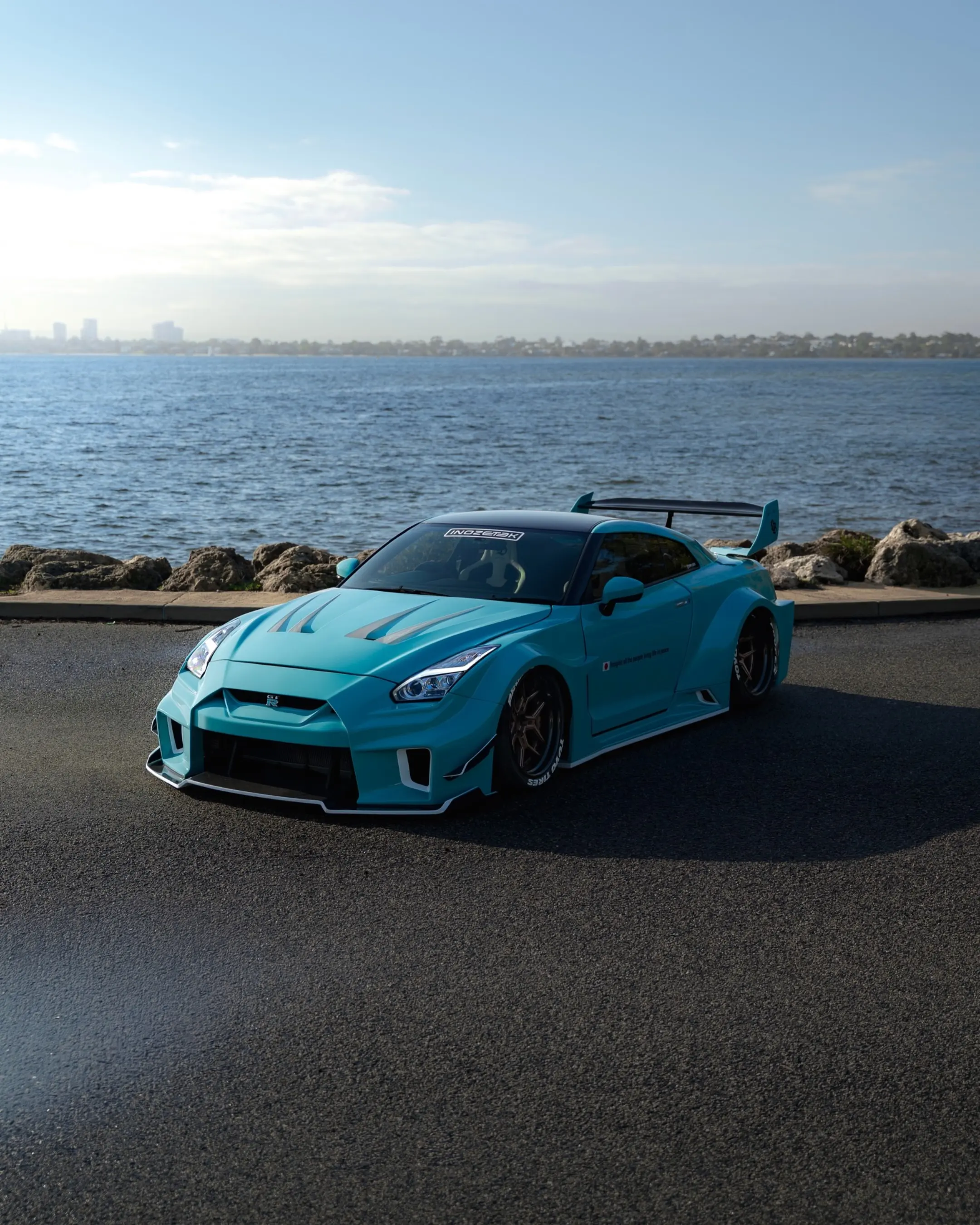 Nissan GT-R R35 Liberty Walk, the side of the car by the water.