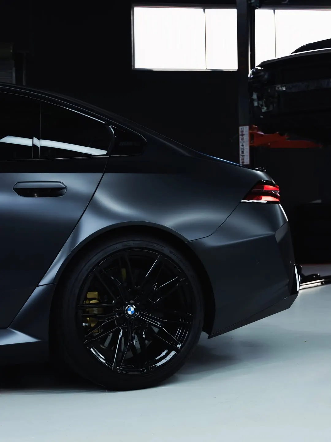 Matte film across the rear wheel and flank of the BMW M5