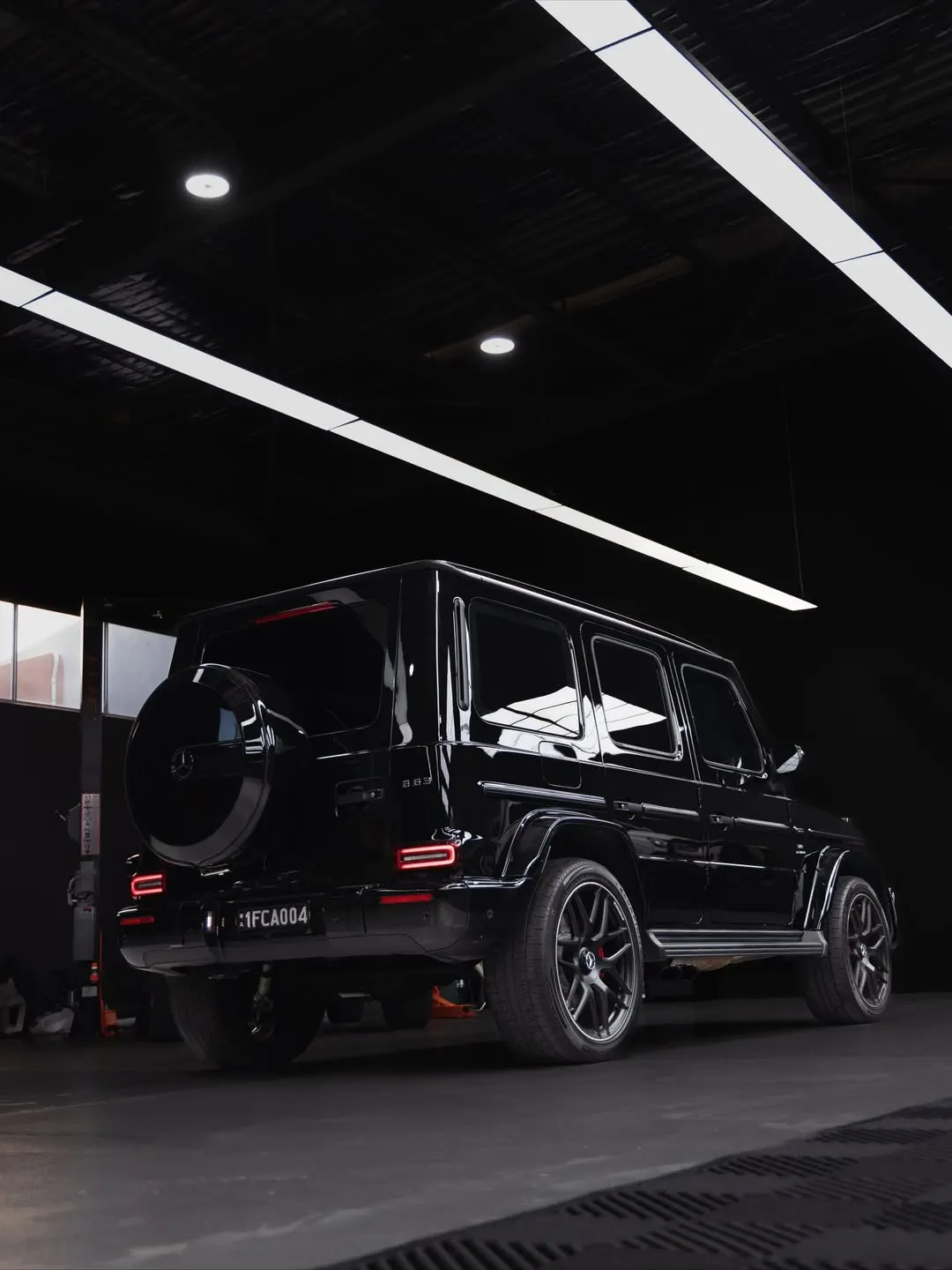 Side profile of the black Mercedes-AMG G63 under gloss clear film