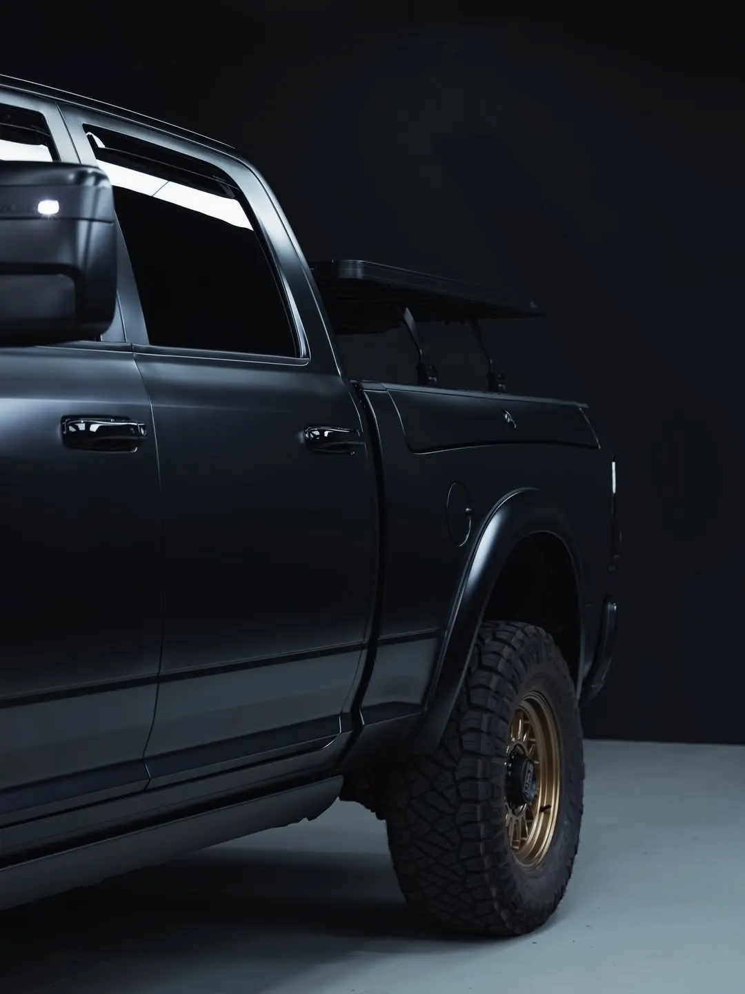 RAM 2500 finished in satin black, side profile in the studio