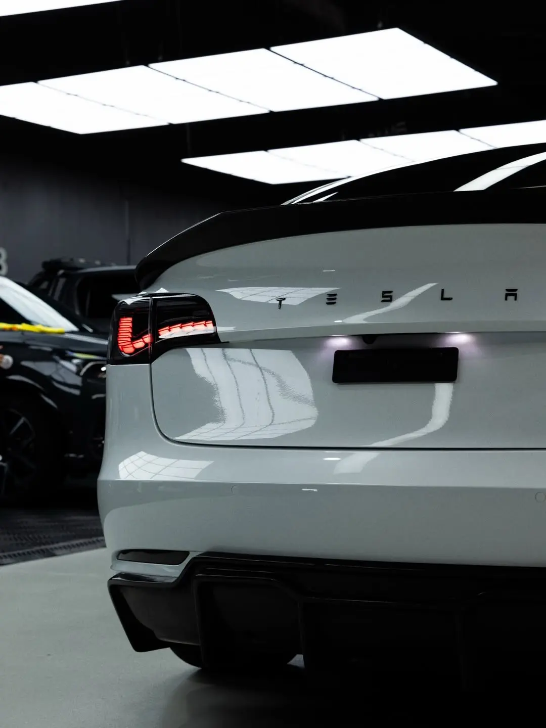 Tesla Model 3, the boot lid and badge.